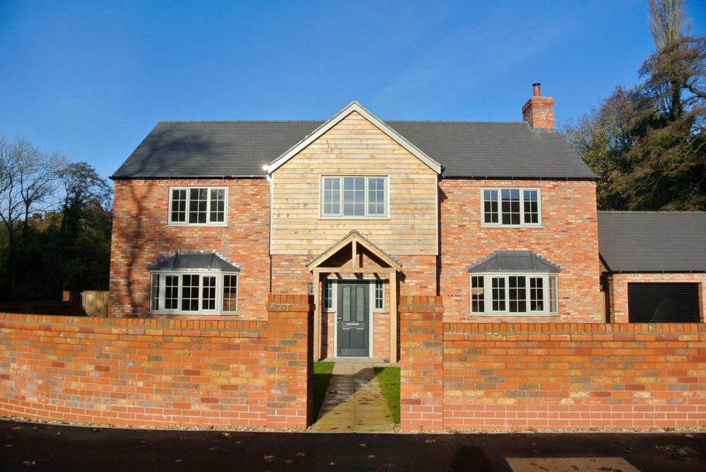 New build home with wooden cladding, pvcu windows and composite door