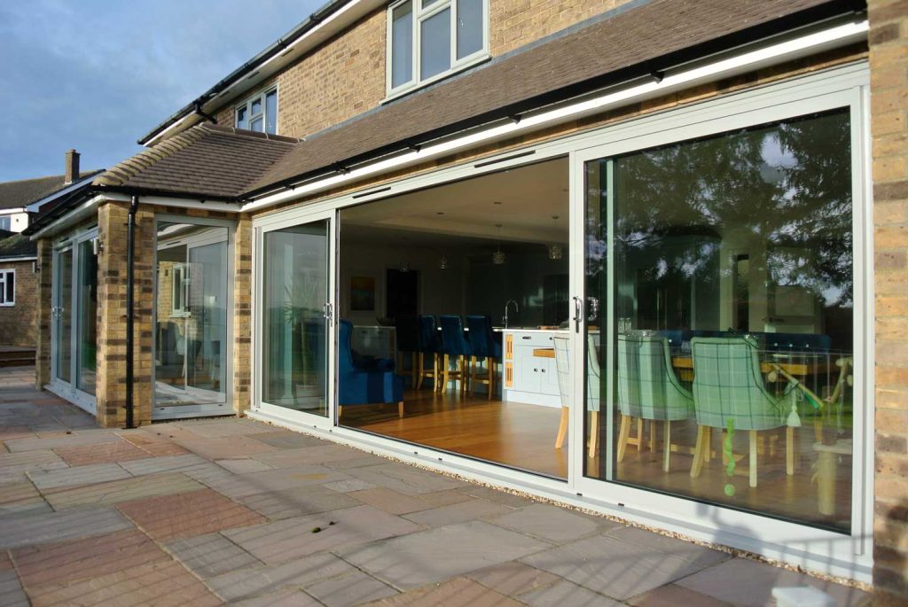 Large aluminium patio sliding doors opening into kitchen 